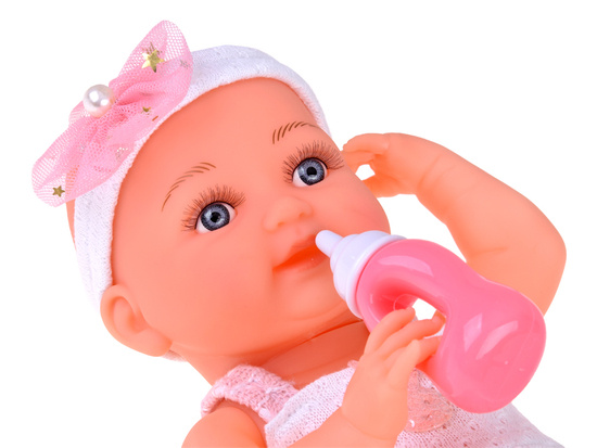 Rubber baby doll in a pink dress, bottle, pacifier ZA5235